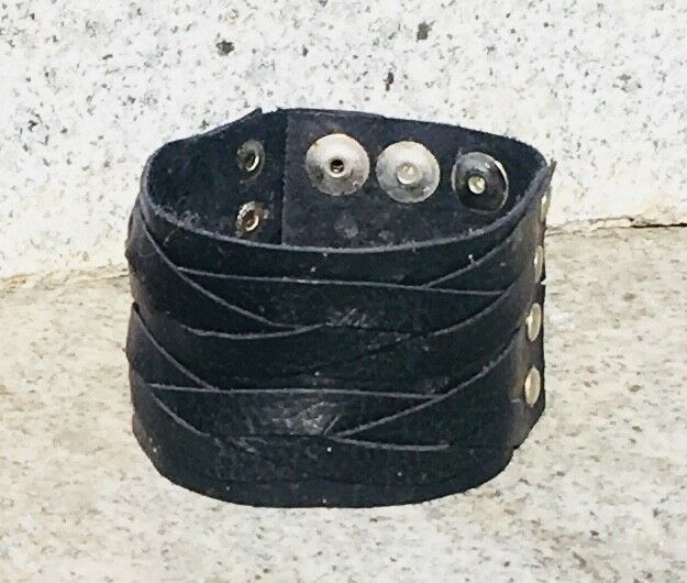 Leather wristband handmade from black leather plaited and secured with chrome finished press studs.