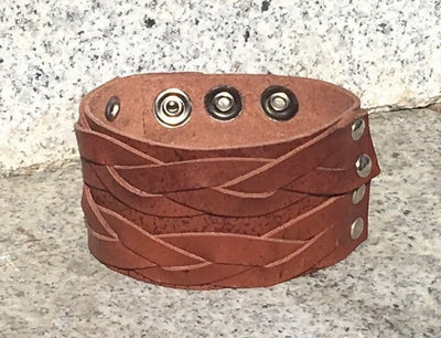 Leather wristband handmade from brown leather plaited and secured with chrome finished press studs.