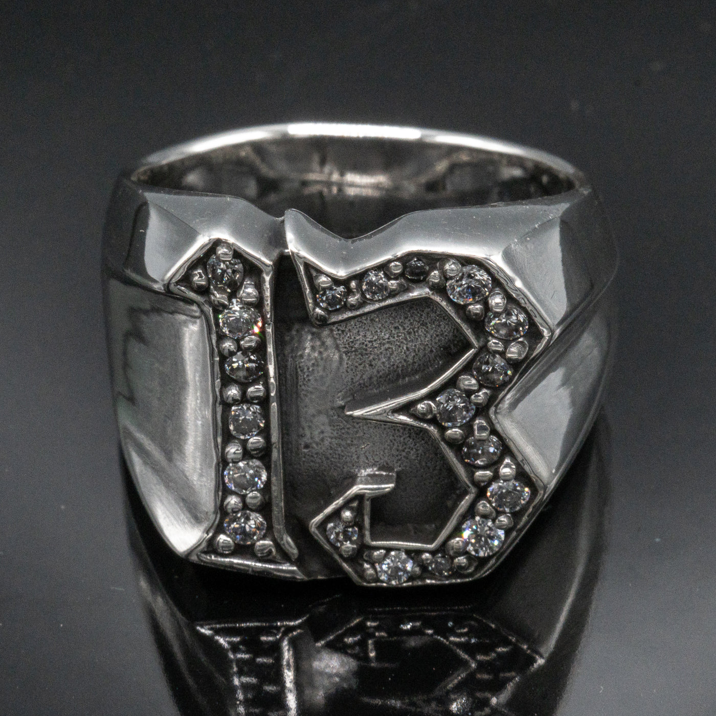 Carved 13 ring made from 925 sterling silver, encrusted in 17 clear  cubic zirconia stones.  Great statement piece, looks great on
