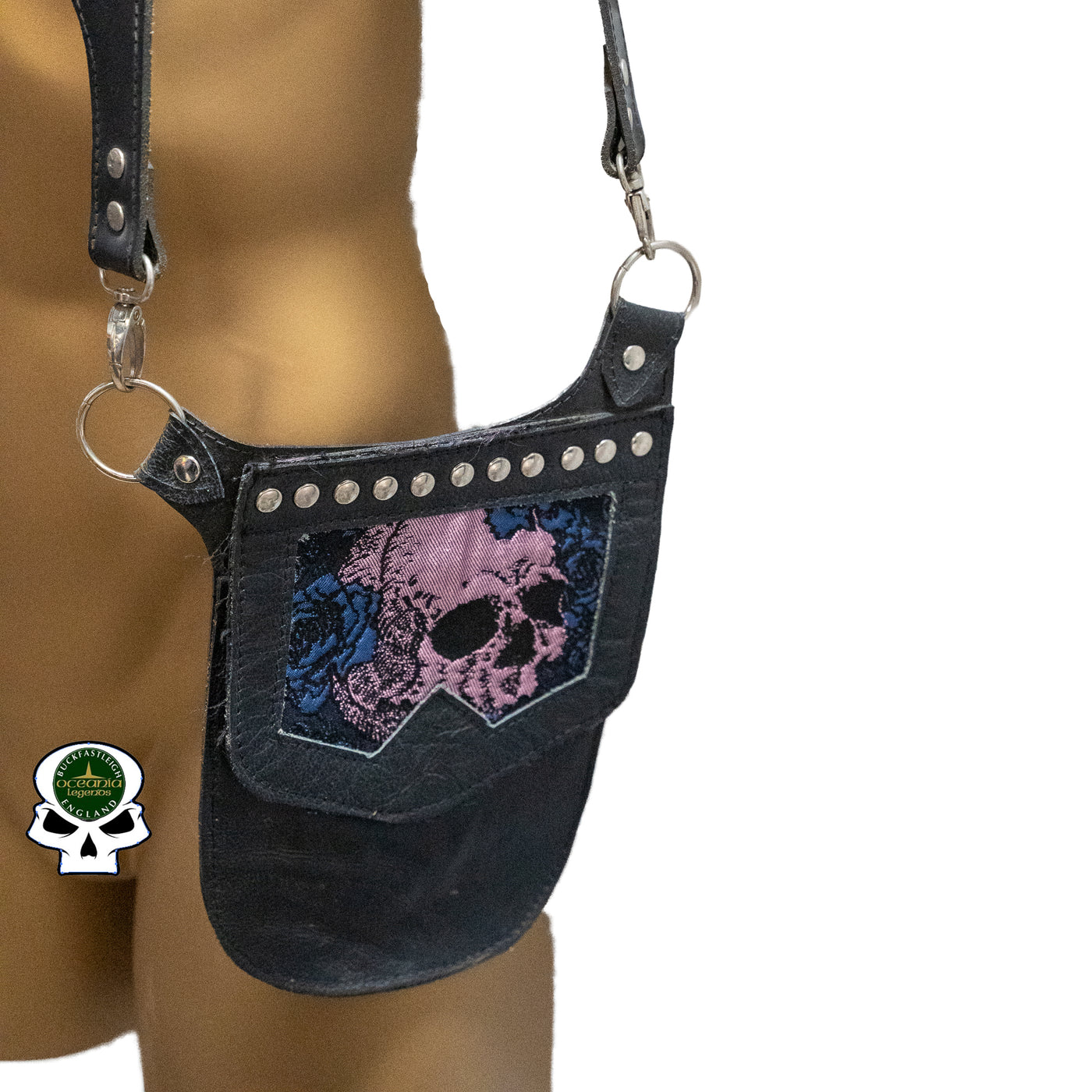 Real Leather back holster to keep your belongings and valuables safe.  It has an adjustable strap with buckles at the front with chrome effect studs in various places, rings that sit on the shoulders and another buckle securing at the back.  on the side is a decorative pouch for your valuables to keep them out of site.  This one has a skull & blue rose detail on the pouch