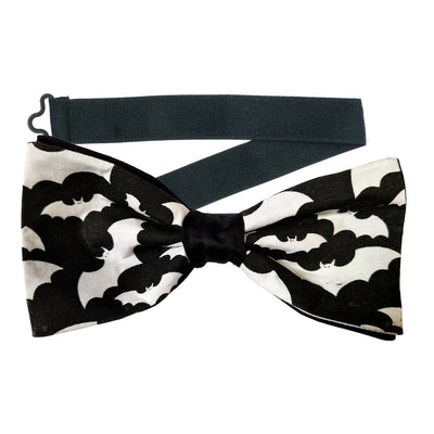 Bat Design with White Bats on Black Cotton.  The Bow tie which is on a sliding ribbon and hook attachment so very easy to attach. Handmade from 100% Cotton

