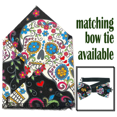 Black  fabric with candy/sugar skulls with day of the dead style designs, handmade bow tie & pocket square.  The bow tie is on a sliding ribbon to easily attach. The pocket square is  25 cmx25 cm, pre-tied so just pop it straight in your pocket
