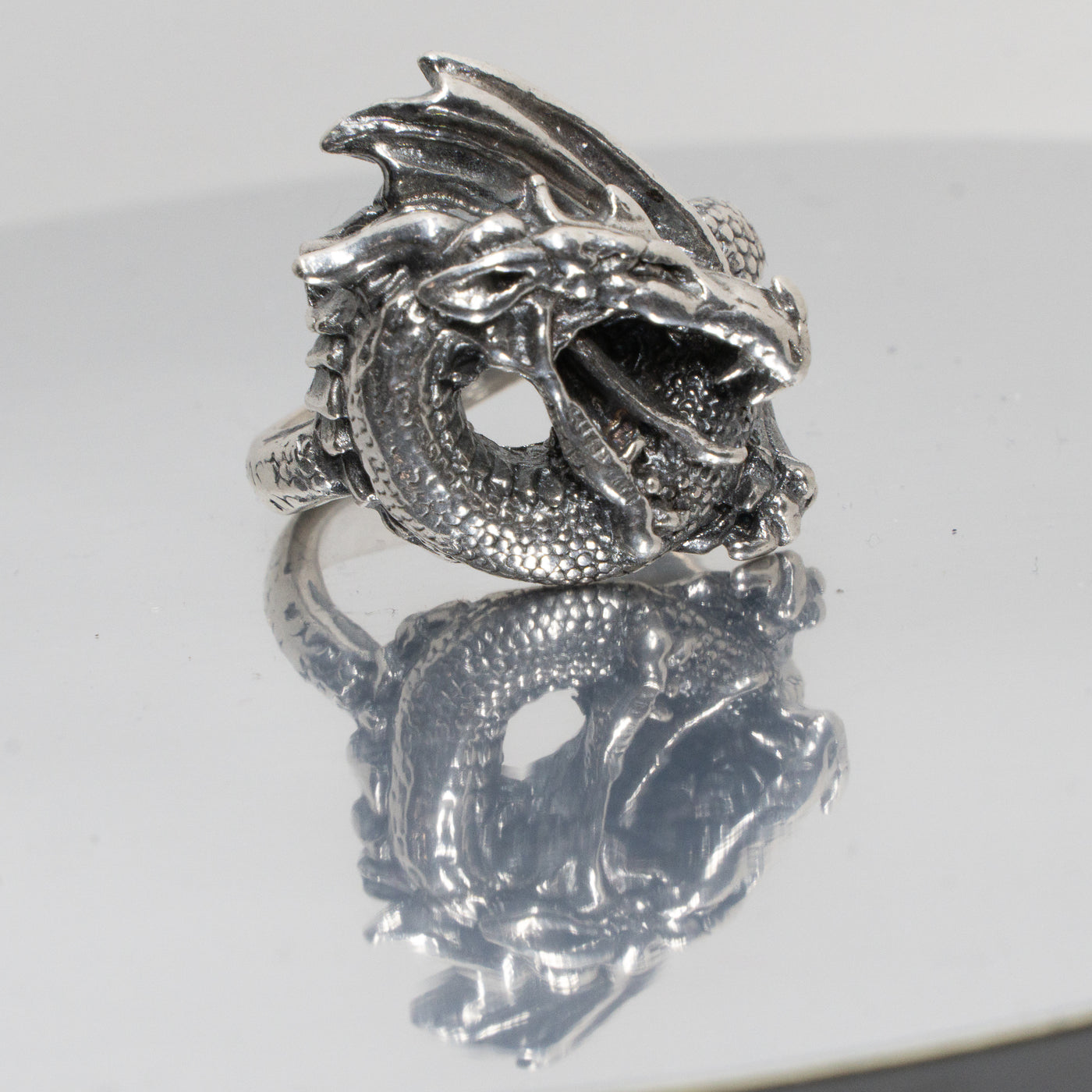 Dragon Ring. Made from 925 solid sterling ring.  The dragon is very realistic with open mouth ready to breath fire, the scaled body & wing curls around your finger, great texturing and detailing throughout. Available in sizes M - Z+5.  Please ask for alternative sizes.
