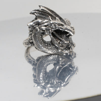 Dragon Ring. Made from 925 solid sterling ring.  The dragon is very realistic with open mouth ready to breath fire, the scaled body & wing curls around your finger, great texturing and detailing throughout. Available in sizes M - Z+5.  Please ask for alternative sizes.
