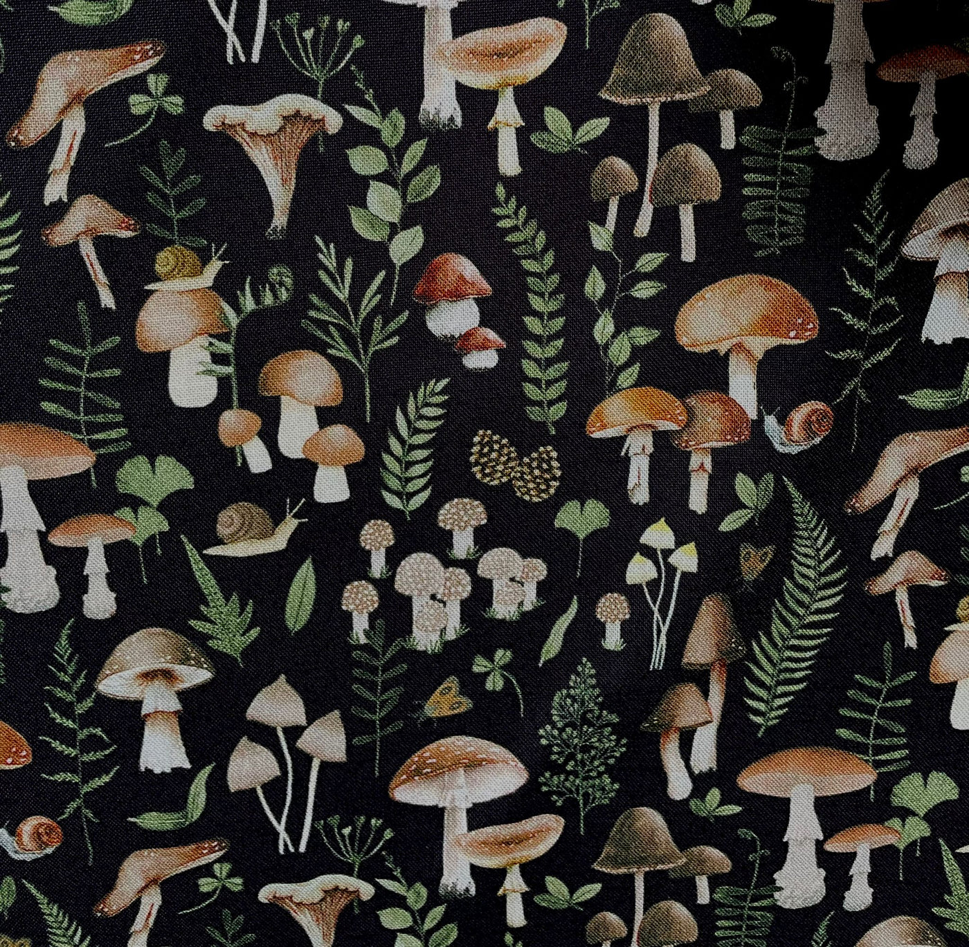 100% Cotton machine washable fabric, black background with toadstools & mushrooms, moths & snails, ferns &  foliage