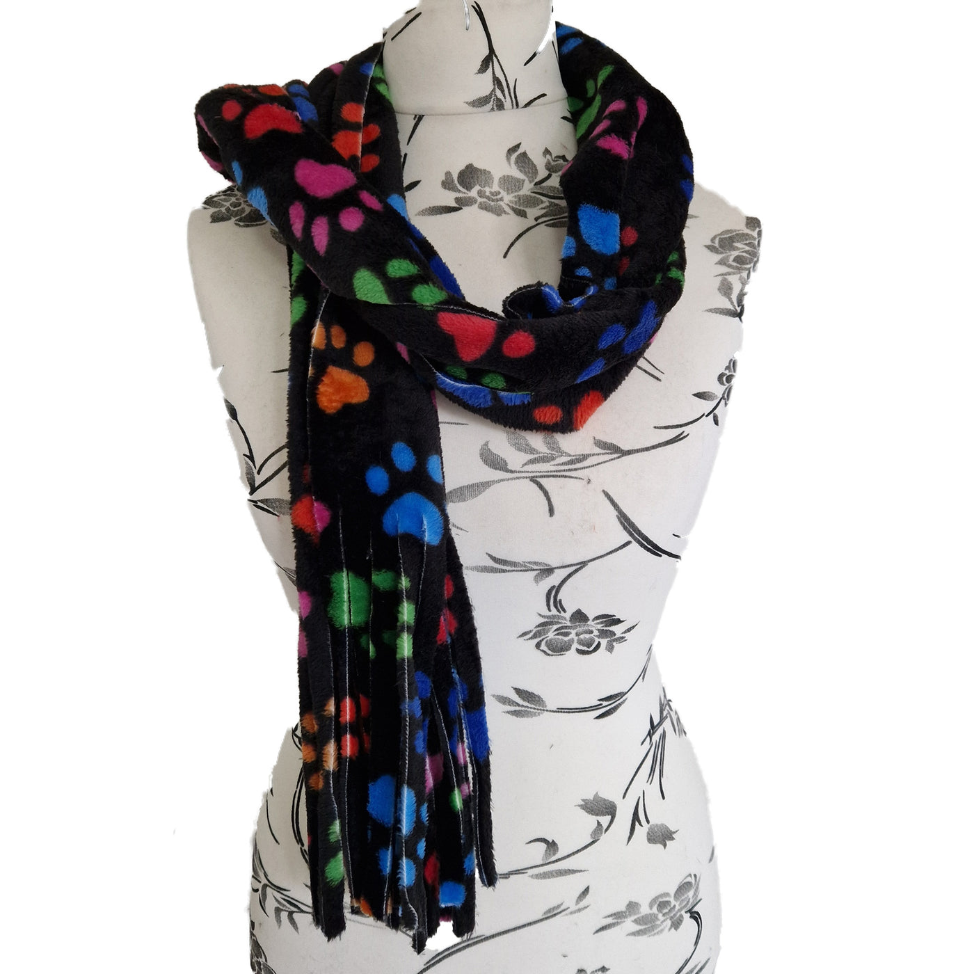 Bright multicoloured paw prints on black fleece fabric in our handmade scarf, approximately 180cm x 28cm with a fringed edge
