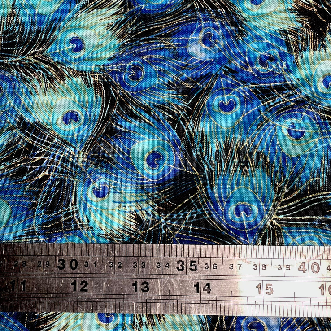 Beautifull peacock eye feather fabric in bright blues & greens, available in various lengths, from fat quarters to half yards & up to full metres or yards