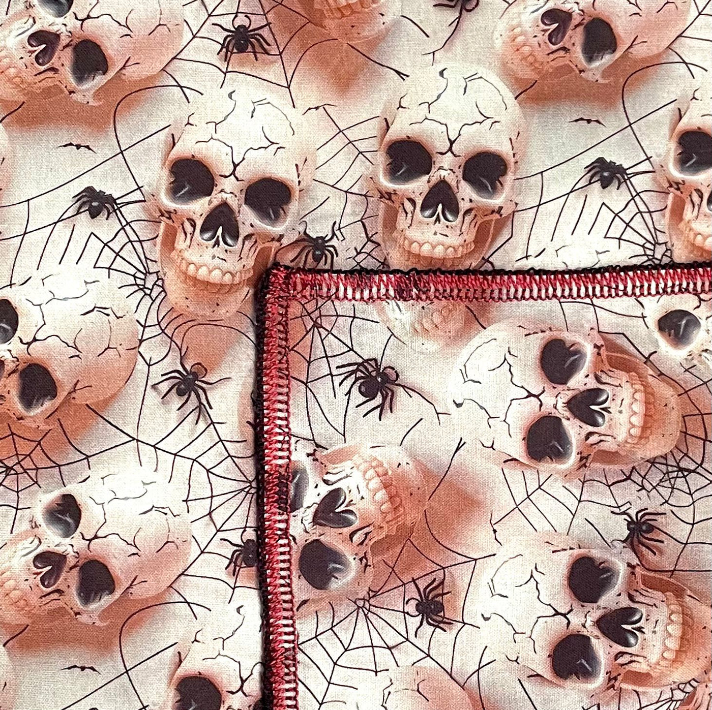 Perfect for halloween, skulls and spider webs printed in a 3D effect on light pink fabric. Handmade square bandana approx. 21.5" x 21.5" machine washable 100% cotton
