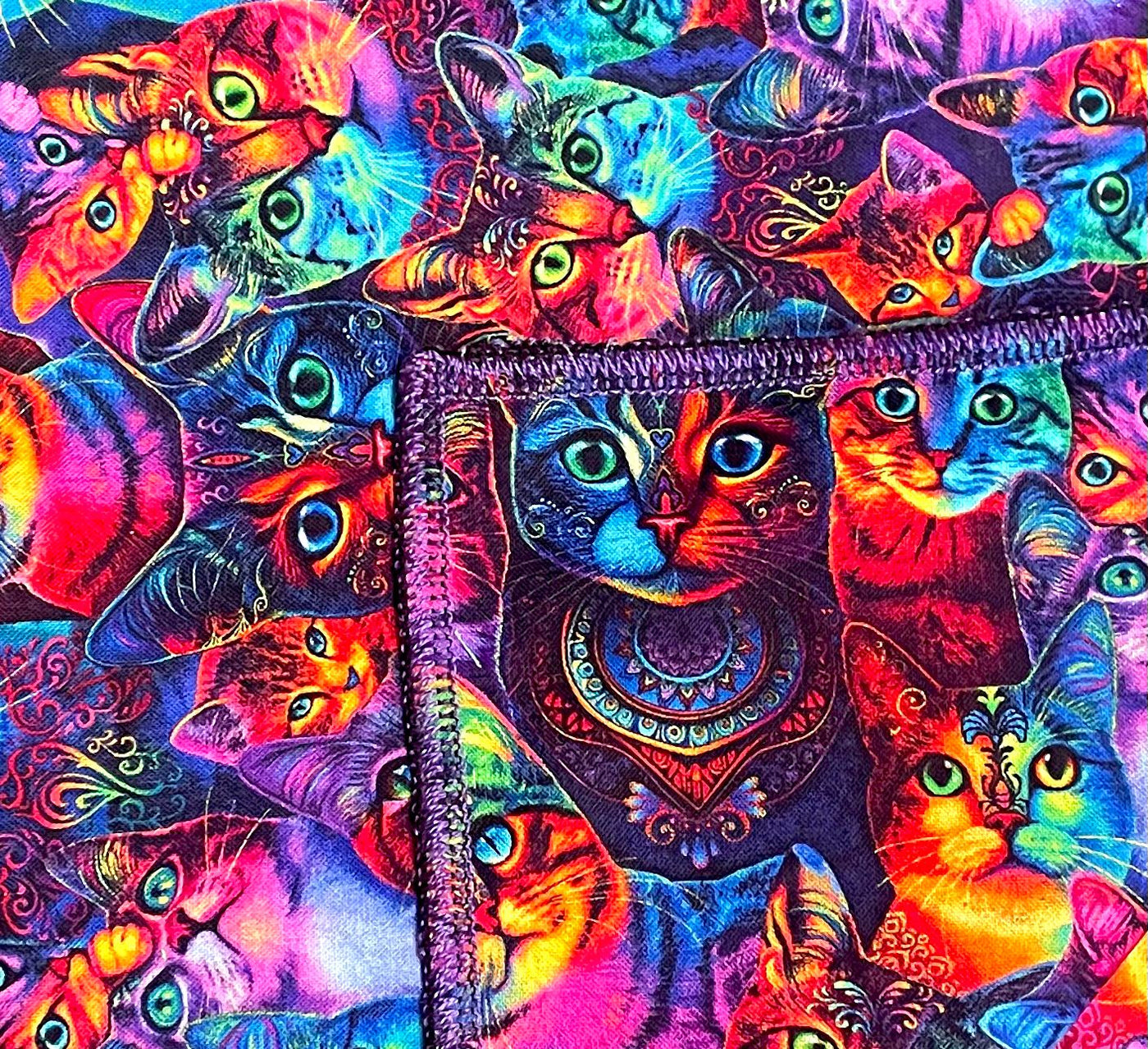 Bright & Vibrant material with psychedelic rainbow cats with mandala designs on their heads & chest.  Handmade square bandana approx. 21.5" x 21.5" machine washable 100% cotton
