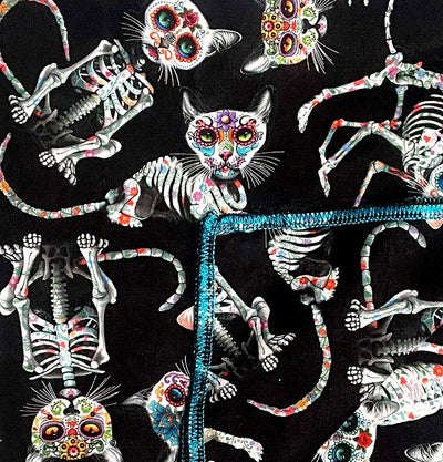 Handmade bandana, with skeleton cats decorated in day of the dead designs on black fabric.  You can wear our bandana as a thin band or wrap it to cover your entire head, great for sun cover.  You can even wear it as a neckerchief or wrist wrap.  It is approx. 21.5" x 21.5" 100% machine washable cotton from Timeless Treasures