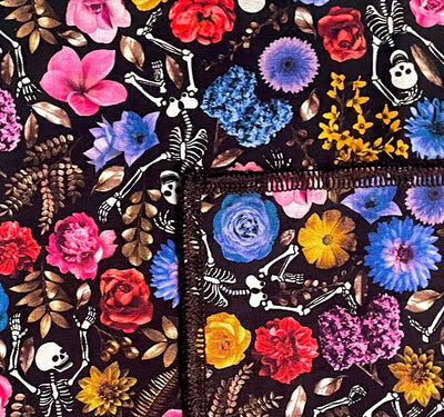 Handmade bandana, skeletons dancing amongst a mass of flowers in various types and colours. approx. 21.5" x 21.5" 100% machine washable cotton
