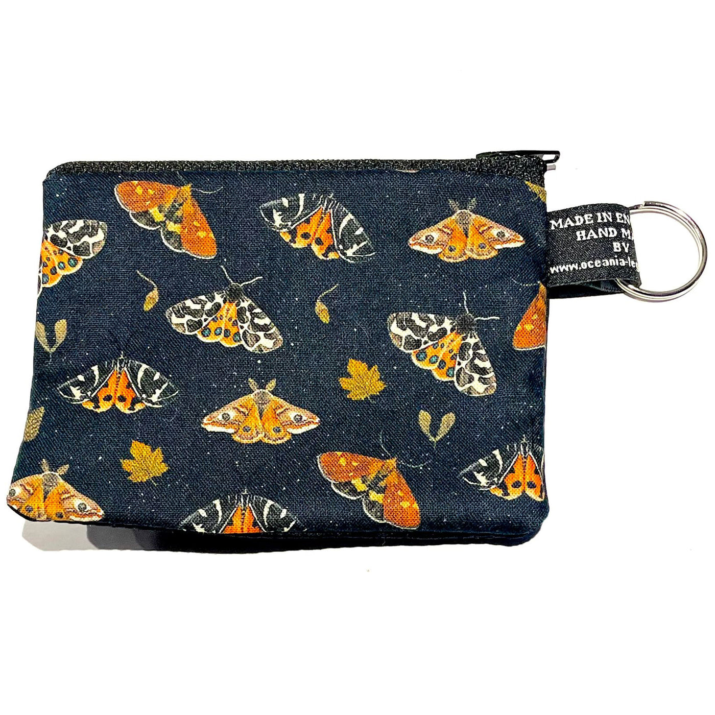 Tiger moths, acorns & leaves cover this designer 100% cotton fabric, handmade into our coin & card purse, lovely autumnal colours on a black background