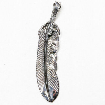 Feather pendant with a claw clutching the top.  925 sterling silver